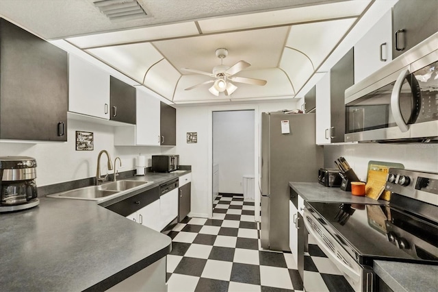 3105/3109 Vasco St, Punta Gorda, FL 33950 - kitchen with appliances with stainless steel finishes, dark flooring, a ceiling fan, dark countertops, and white cabinetry