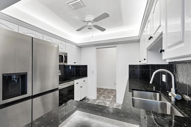 3105/3109 Vasco St, Punta Gorda, FL 33950 - kitchen with stainless steel appliances, decorative backsplash, ceiling fan, white cabinets, and a textured ceiling