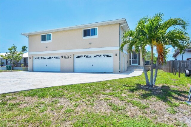 3105/3109 Vasco St, Punta Gorda, FL 33950 - view of front of house with stucco siding, a garage, and concrete driveway