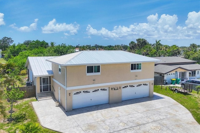 3105/3109 Vasco St, Punta Gorda, FL 33950 - view of front facade with stucco siding, a garage, concrete driveway, and a metal roof