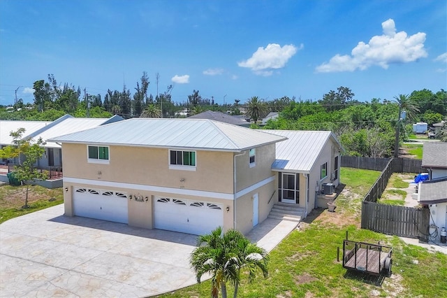 3105/3109 Vasco St, Punta Gorda, FL 33950 - view of front of property featuring stucco siding, a garage, a metal roof, and concrete driveway