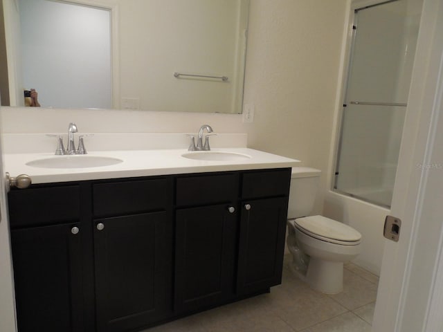 4830 Cazes Ave, North Port, FL 34287 - full bathroom featuring tile patterned floors, double vanity, toilet, and shower / bath combination with glass door