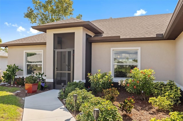 16094 Ortega Dr, Punta Gorda, FL 33955 - property entrance with a shingled roof and stucco siding