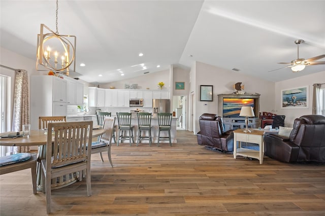 16094 Ortega Dr, Punta Gorda, FL 33955 - dining room with light wood-style floors, a chandelier, ceiling fan, recessed lighting, and high vaulted ceiling