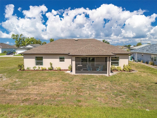 16094 Ortega Dr, Punta Gorda, FL 33955 - rear view of house featuring stucco siding, a sunroom, a yard, and a shingled roof