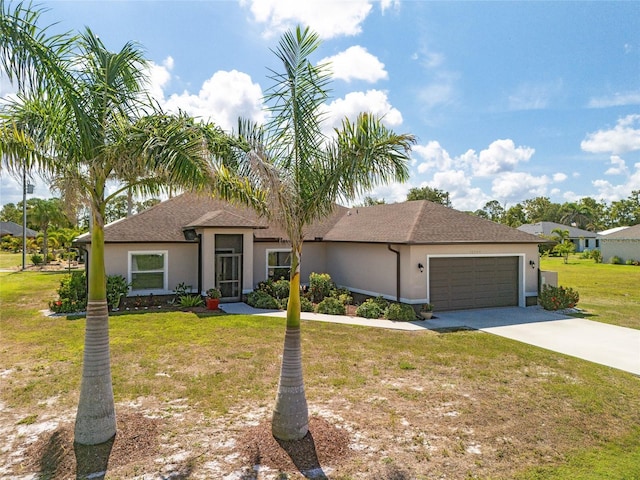 16094 Ortega Dr, Punta Gorda, FL 33955 - view of front of home with a garage, concrete driveway, stucco siding, and a front lawn