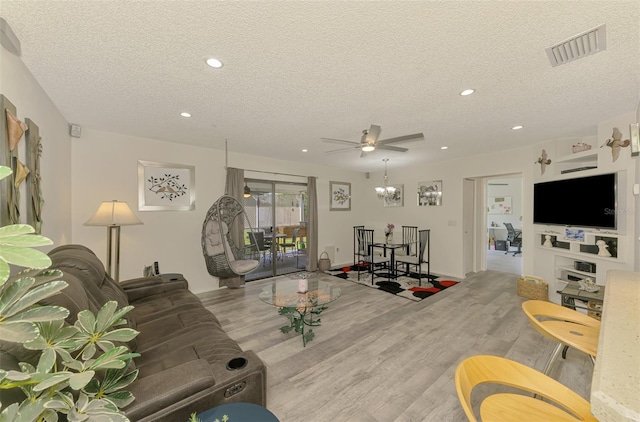 4044 S Salford Blvd, North Port, FL 34287 - living room with a textured ceiling, wood finished floors, recessed lighting, ceiling fan, and a chandelier