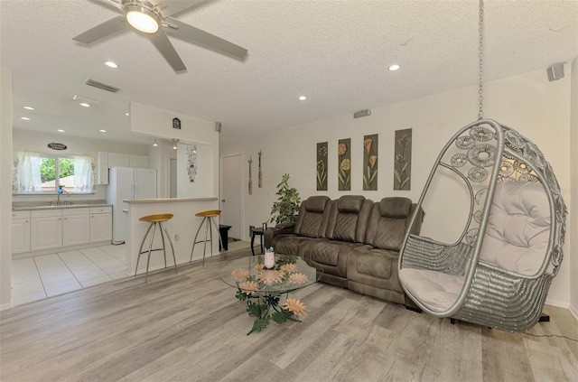 4044 S Salford Blvd, North Port, FL 34287 - living room featuring light wood-style floors, a textured ceiling, recessed lighting, and a ceiling fan