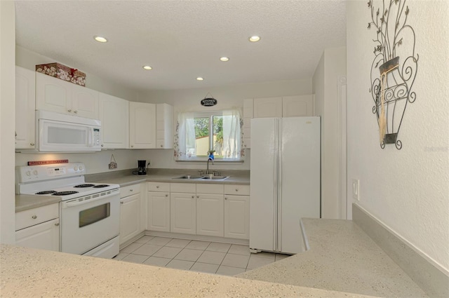 4044 S Salford Blvd, North Port, FL 34287 - kitchen with white appliances, a sink, recessed lighting, white cabinets, and light tile patterned floors