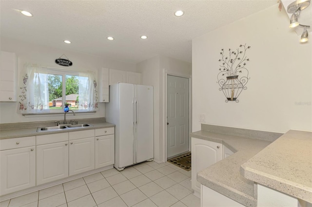 4044 S Salford Blvd, North Port, FL 34287 - kitchen featuring freestanding refrigerator, a sink, white cabinetry, recessed lighting, and light countertops