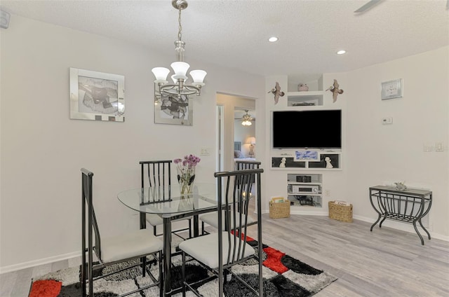 4044 S Salford Blvd, North Port, FL 34287 - dining area featuring wood finished floors, recessed lighting, a chandelier, a textured ceiling, and baseboards