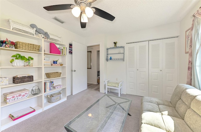 4044 S Salford Blvd, North Port, FL 34287 - living room featuring carpet floors, ceiling fan, and a textured ceiling