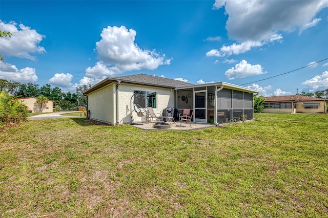 4044 S Salford Blvd, North Port, FL 34287 - rear view of house featuring a sunroom, a patio, a lawn, a fire pit, and stucco siding