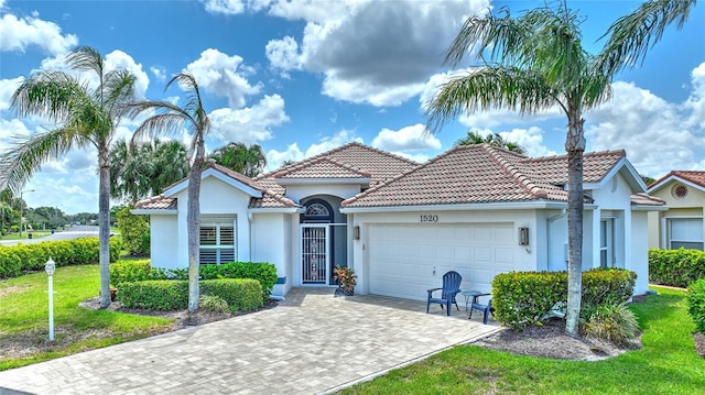 1520 Islamorada Blvd, Punta Gorda, FL 33955 - mediterranean / spanish-style home featuring a garage, stucco siding, and a tile roof