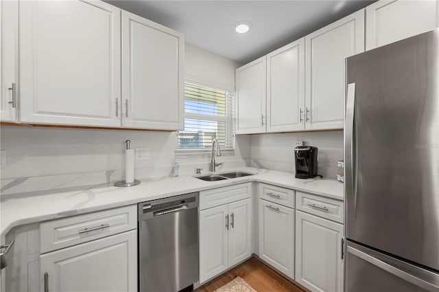 1080 Bal Harbor Blvd Unit 12C, Punta Gorda, FL 33950 - kitchen with stainless steel appliances, a sink, white cabinets, wood finished floors, and recessed lighting