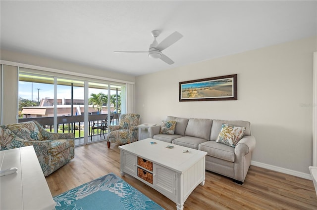 1080 Bal Harbor Blvd Unit 12C, Punta Gorda, FL 33950 - living area with ceiling fan, light wood-style floors, and baseboards