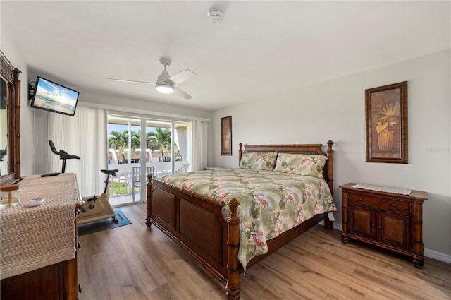 1080 Bal Harbor Blvd Unit 12C, Punta Gorda, FL 33950 - bedroom featuring access to exterior, light wood finished floors, ceiling fan, and baseboards