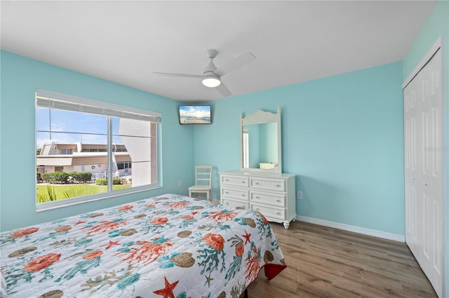 1080 Bal Harbor Blvd Unit 12C, Punta Gorda, FL 33950 - bedroom featuring a closet, wood finished floors, baseboards, and ceiling fan