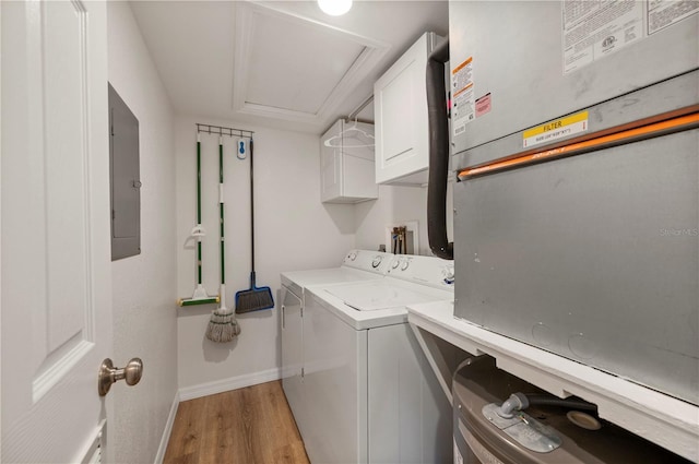 1080 Bal Harbor Blvd Unit 12C, Punta Gorda, FL 33950 - laundry room with cabinet space, independent washer and dryer, light wood-style flooring, electric panel, and baseboards
