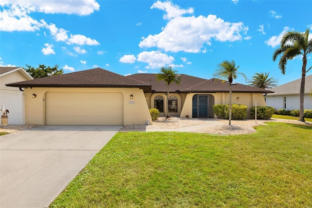 2152 Taiwan Ct, Punta Gorda, FL 33983 - view of front facade featuring stucco siding, a garage, driveway, and a front yard