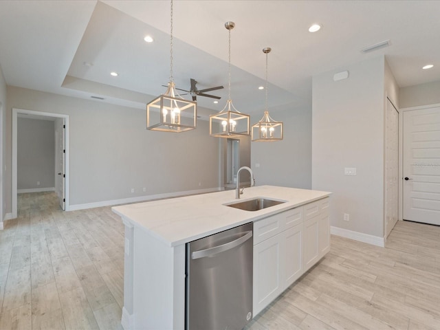 223 Australian Dr, Rotonda West, FL 33947 - kitchen with dishwasher, a sink, an island with sink, light wood-style floors, and baseboards