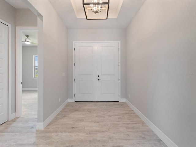 223 Australian Dr, Rotonda West, FL 33947 - entryway featuring light wood finished floors, a chandelier, and baseboards