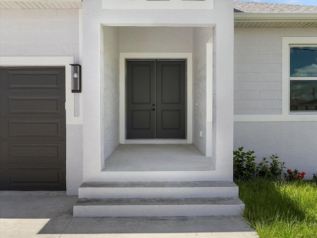 223 Australian Dr, Rotonda West, FL 33947 - doorway to property with a garage, a shingled roof, and stucco siding
