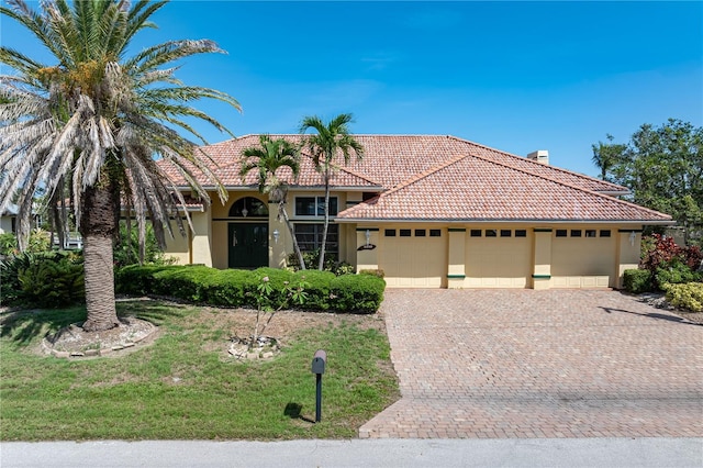 5023 Key Largo Dr, Punta Gorda, FL 33950 - mediterranean / spanish home with a tile roof, a garage, stucco siding, and driveway