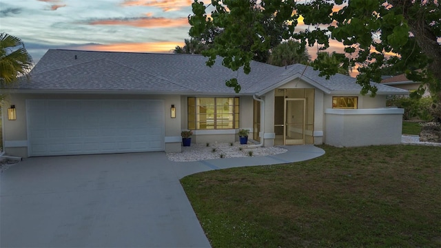 2442 Rio De Janeiro Ave, Punta Gorda, FL 33983 - single story home featuring stucco siding, an attached garage, a shingled roof, concrete driveway, and a lawn