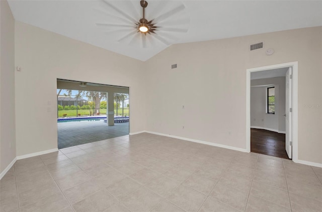 2442 Rio De Janeiro Ave, Punta Gorda, FL 33983 - spare room featuring tile patterned flooring, baseboards, and high vaulted ceiling