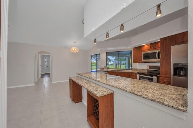 2442 Rio De Janeiro Ave, Punta Gorda, FL 33983 - kitchen with appliances with stainless steel finishes, a peninsula, a sink, light tile patterned floors, and light stone counters