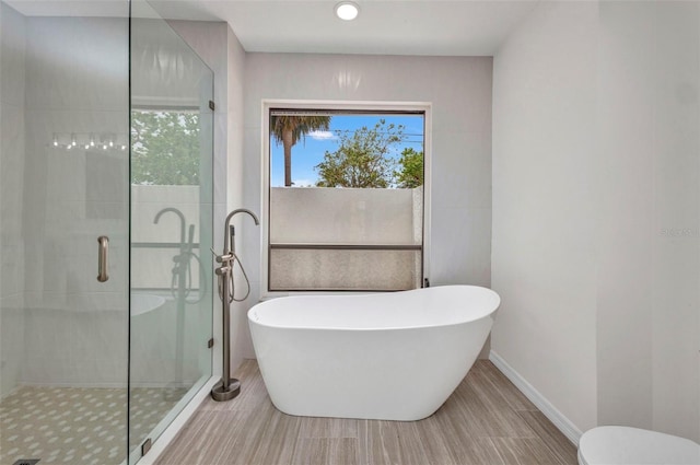 2442 Rio De Janeiro Ave, Punta Gorda, FL 33983 - bathroom with a freestanding bath, a shower stall, baseboards, recessed lighting, and toilet