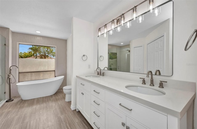 2442 Rio De Janeiro Ave, Punta Gorda, FL 33983 - bathroom with a shower stall, double vanity, a freestanding bath, and toilet