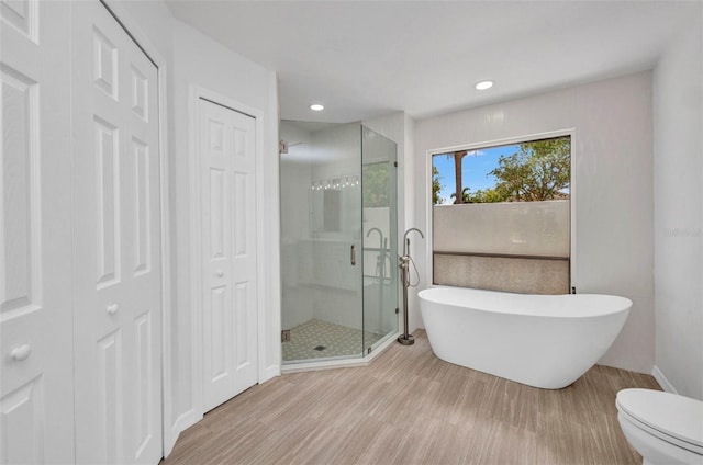 2442 Rio De Janeiro Ave, Punta Gorda, FL 33983 - bathroom featuring a closet, a freestanding tub, a stall shower, recessed lighting, and toilet