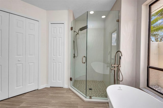2442 Rio De Janeiro Ave, Punta Gorda, FL 33983 - bathroom with a closet, a stall shower, a soaking tub, baseboards, and recessed lighting