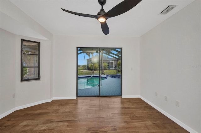 2442 Rio De Janeiro Ave, Punta Gorda, FL 33983 - unfurnished room with plenty of natural light, ceiling fan, wood finished floors, and a sunroom