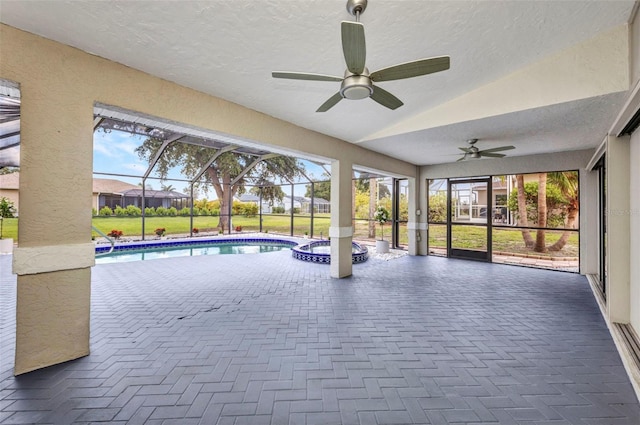 2442 Rio De Janeiro Ave, Punta Gorda, FL 33983 - view of pool featuring ceiling fan, a patio area, a pool with connected hot tub, glass enclosure, and a lawn