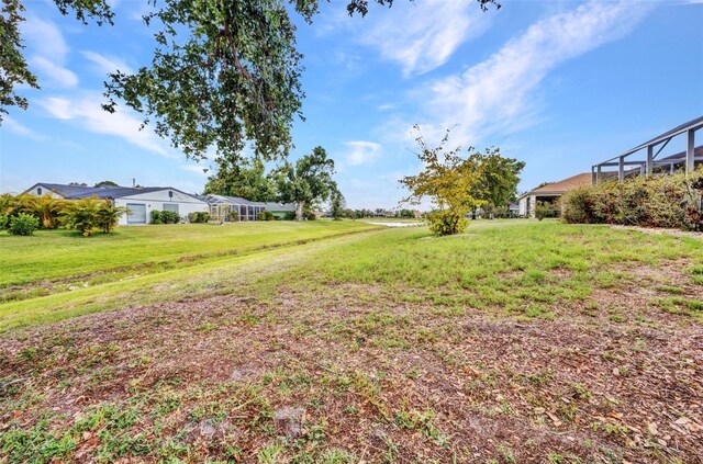 2442 Rio De Janeiro Ave, Punta Gorda, FL 33983 - view of grassy yard featuring a lanai