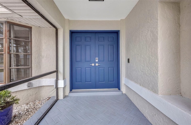 2442 Rio De Janeiro Ave, Punta Gorda, FL 33983 - doorway to property featuring stucco siding