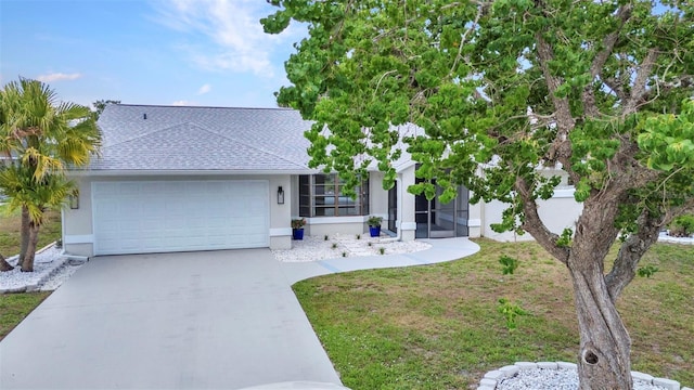 2442 Rio De Janeiro Ave, Punta Gorda, FL 33983 - single story home featuring roof with shingles, an attached garage, driveway, stucco siding, and a front yard