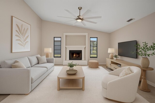 2442 Rio De Janeiro Ave, Punta Gorda, FL 33983 - living area featuring ceiling fan, vaulted ceiling, a lit fireplace, and baseboards