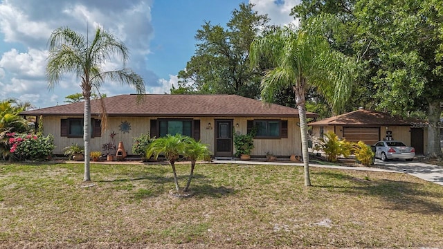 4071 Dekle Ave, North Port, FL 34286 - ranch-style home with a front lawn, concrete driveway, and an attached garage