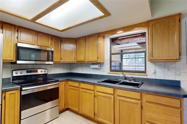 4071 Dekle Ave, North Port, FL 34286 - kitchen with appliances with stainless steel finishes, dark countertops, and backsplash