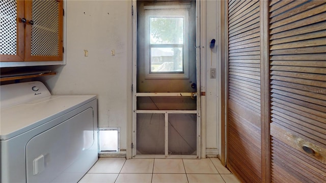 4071 Dekle Ave, North Port, FL 34286 - laundry area with washer / dryer, light tile patterned flooring, and cabinet space