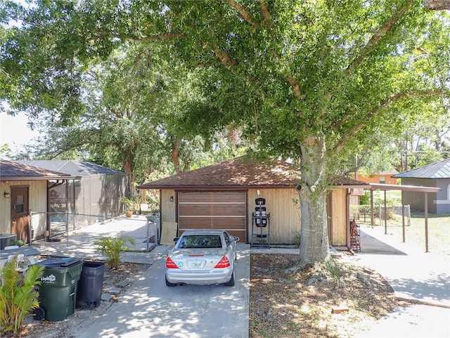 4071 Dekle Ave, North Port, FL 34286 - view of front facade with driveway, a garage, and a shingled roof