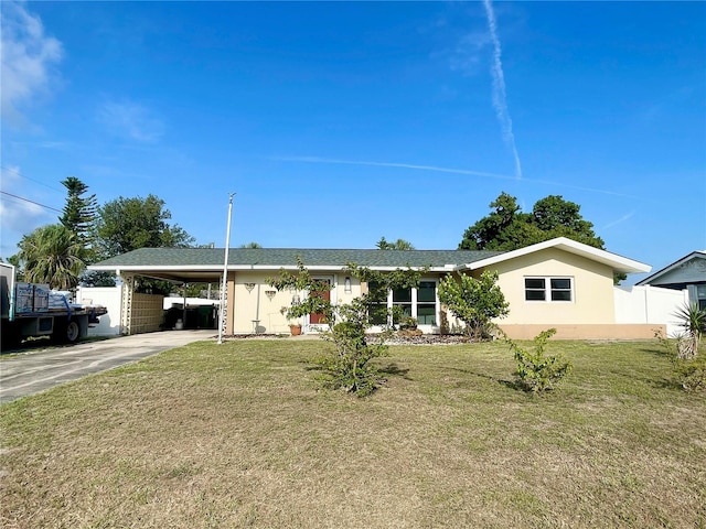 3122 Scranton St, Port Charlotte, FL 33952 - ranch-style home with concrete driveway, an attached carport, a front yard, and stucco siding