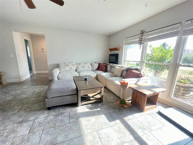3122 Scranton St, Port Charlotte, FL 33952 - living room featuring baseboards, ceiling fan, and stone tile floors