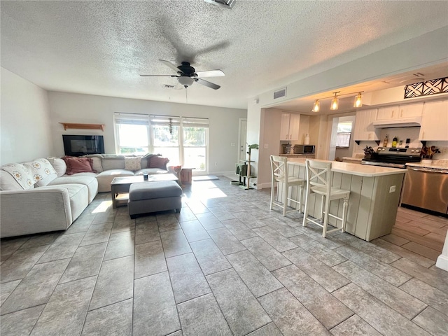 3122 Scranton St, Port Charlotte, FL 33952 - living area featuring a ceiling fan and a textured ceiling