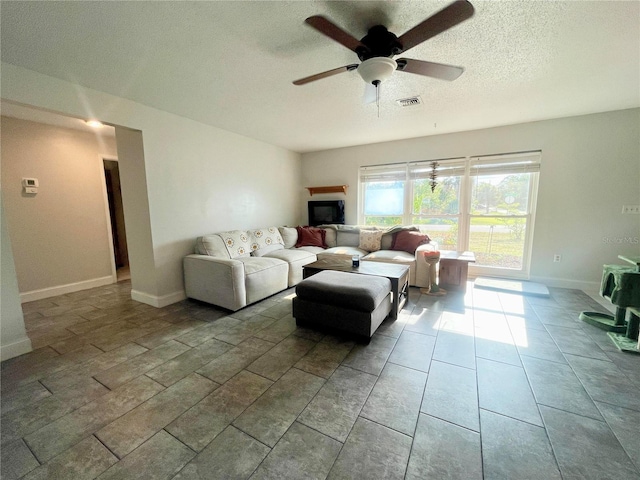 3122 Scranton St, Port Charlotte, FL 33952 - living area with ceiling fan, baseboards, a fireplace, and a textured ceiling