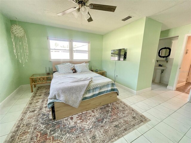 3122 Scranton St, Port Charlotte, FL 33952 - tiled bedroom featuring a textured ceiling, ceiling fan, baseboards, and a sink